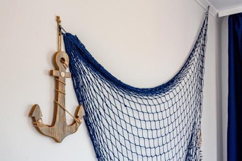 a nautical net hanging on a wall with a anchor at Hostel & Apartments Kołobrzeg in Kołobrzeg