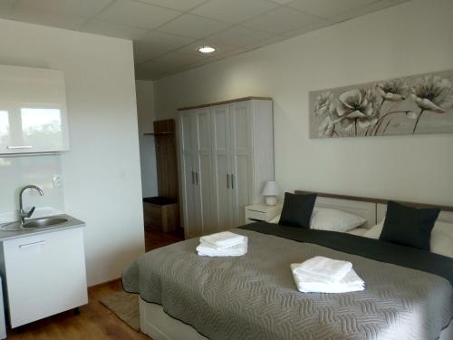 a bedroom with a bed with two towels on it at Penzion Wellness Chechluvka in Dolní Tošanovice