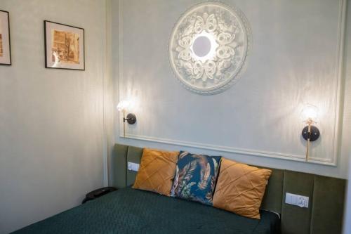托倫的住宿－Domek z Piernika，一间卧室配有带枕头的绿色沙发