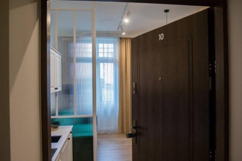 托倫的住宿－Domek z Piernika，厨房设有一扇门,可通往带绿色墙壁的厨房