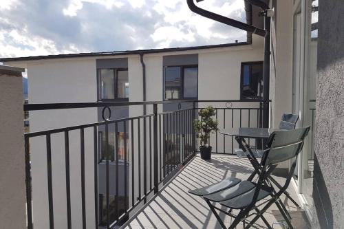 a balcony with a table and two chairs on it at Living Home, apartament cu două dormitoare și două băi in Cisnădie