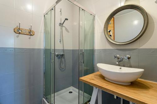 a bathroom with a sink and a shower at Hostel & Apartments Kołobrzeg in Kołobrzeg