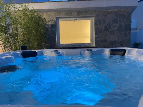 a large blue pool with chairs in front of a window at Relais Manfredi in Castellammare di Stabia