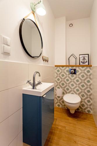 a bathroom with a sink and a mirror at Hostel & Apartments Kołobrzeg in Kołobrzeg