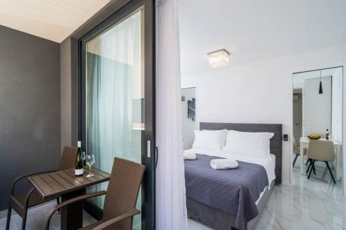 a bedroom with a bed and a table and a room with a bed at Luxury Downtown West Apartment Dubrovnik in Dubrovnik
