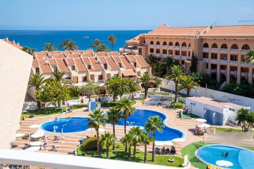 an aerial view of a resort with two pools at Tenerife South Apartments in Playa de las Americas