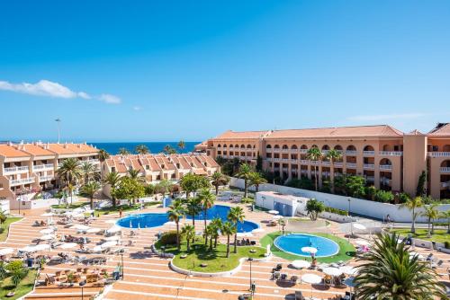 an aerial view of a resort with two pools at Tenerife South Apartments in Playa de las Americas