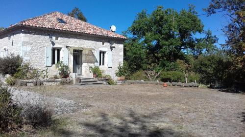 a small white stone house with a yard at Domaine de Séguéla in Fargues