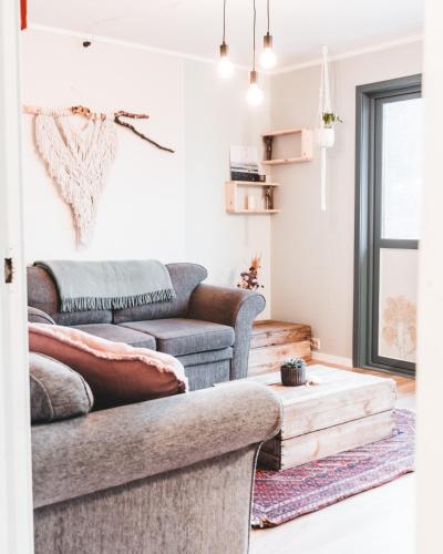 a living room with two couches and a coffee table at FURU Hostel & Café in Bøstad