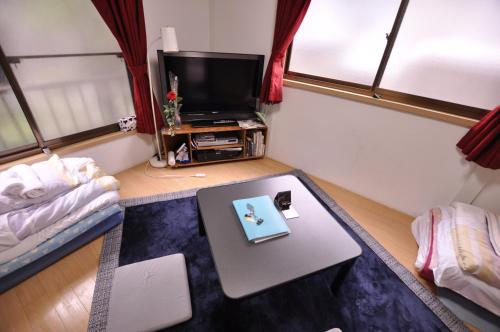 a small living room with a table and a tv at FUJIハイツ #国分寺 #東京&新宿&吉祥寺&高尾山 直行 #TOKYO Kokubunji 10min!! Easy to Shinjuku&SHIBUYA in Kokubunji