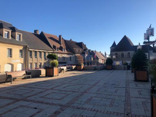 a street in a town with benches and buildings at Appartement centre historique Sancerre in Sancerre