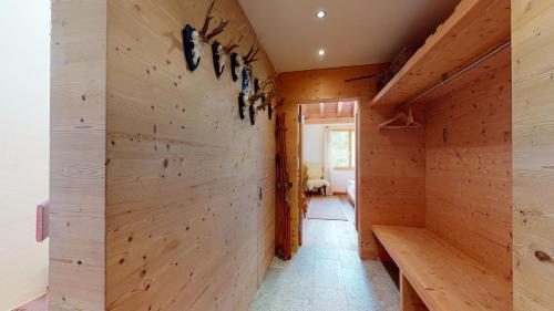 a room with wood paneling and a hallway at Abitaziun Blaunca - Maloja in Maloja