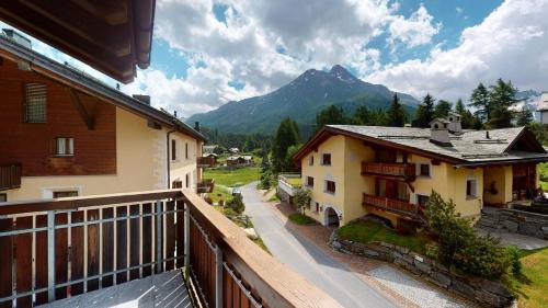 a balcony of a house with a view of a mountain at Abitaziun Blaunca - Maloja in Maloja