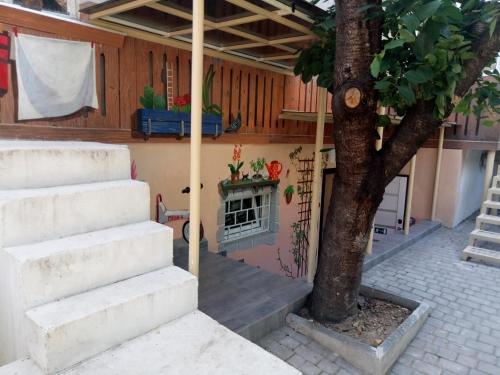 a house with stairs and a tree in the courtyard at Женский Hostel Dvor in Odesa