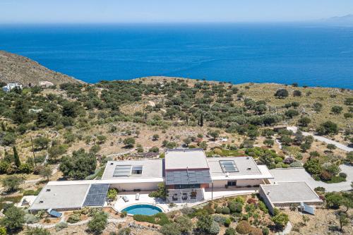 an aerial view of a house with the ocean in the background at Villa The Longhouse- Pool-Sauna-Gym- Panormaic Seaview in Sellía