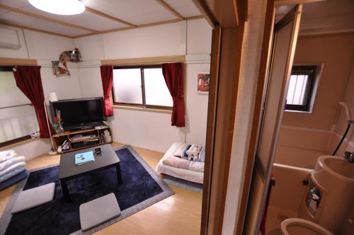 a living room with a table and a tv at FUJIハイツ #国分寺 #東京&新宿&吉祥寺&高尾山 直行 #TOKYO Kokubunji 10min!! Easy to Shinjuku&SHIBUYA in Kokubunji