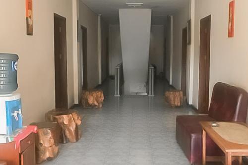 a hallway with a room with wooden logs in it at RedDoorz near Pantai Citepus Pelabuhan Ratu in Sukabumi