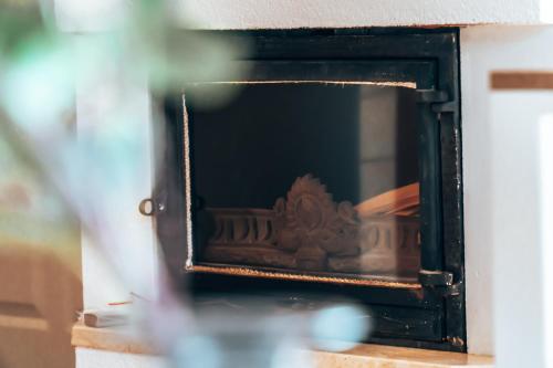 a fireplace with a mirror in a room at Lake Park Łagów in Łagów