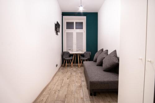 a living room with a couch and a table at Revolution Aparts - Rewolucji 27 in Łódź