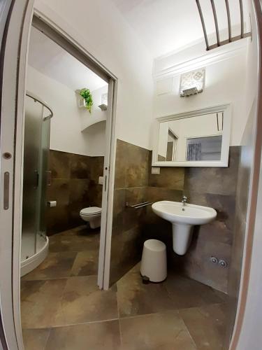 a bathroom with a sink and a toilet and a mirror at Le Maioliche in Vasto