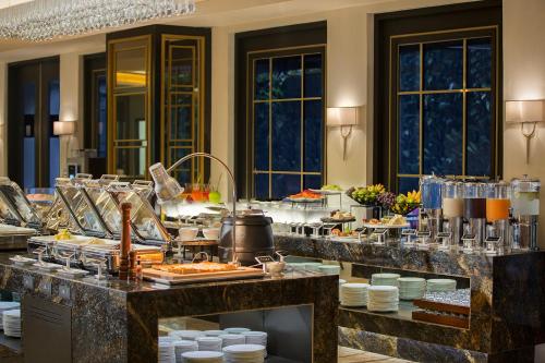 a buffet line with food in a hotel room at Swiss-Belboutique Yogyakarta in Yogyakarta