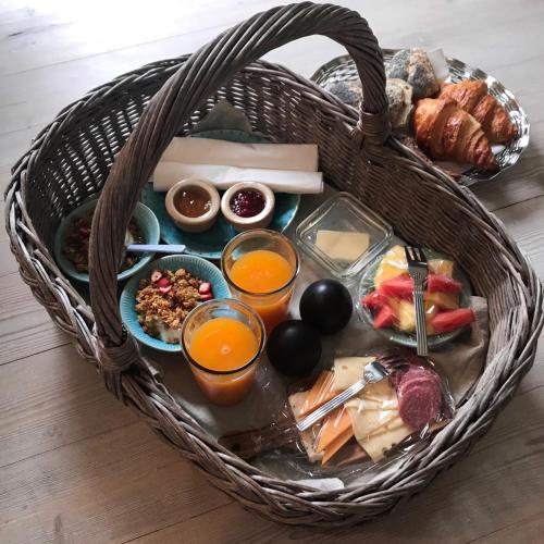 a basket filled with different types of food and drinks at Svenskebakken Bed & Breakfast in Roskilde