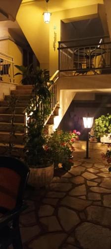 a lobby with stairs and flowers and a light at Vanta Studio in Limenas