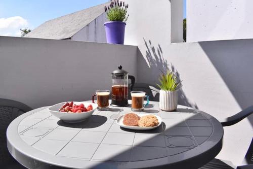 a table with bowls of fruit and drinks on a patio at Causeway Coast Apartments Cora Marine in Ballycastle