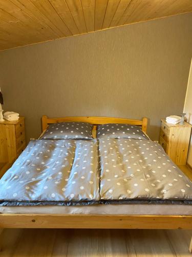 a bed with two pillows on it in a room at Penzion U Martina in Mariánské Lázně