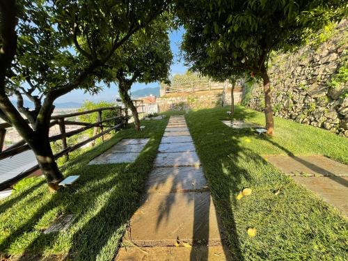 a path with trees and a fence in a park at Relais Manfredi in Castellammare di Stabia