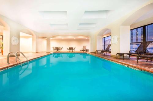 a swimming pool with blue water in a building at Wyndham New Orleans French Quarter in New Orleans