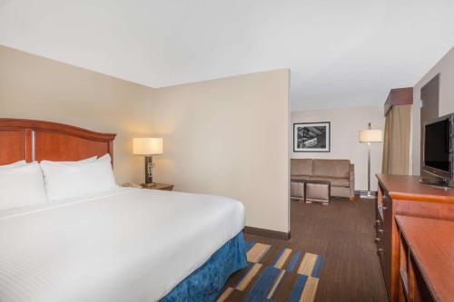 a hotel room with a bed and a flat screen tv at Wyndham New Orleans French Quarter in New Orleans