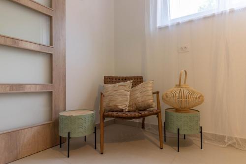 a room with a chair and a table and a vase at Beautiful villa Foska with private Pool near the beach in Marčana