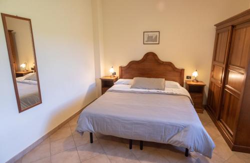 a bedroom with a bed and two lights on two tables at Residenza Il Falchetto in Assisi