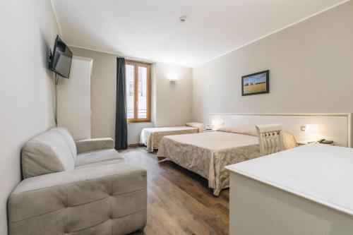Postel nebo postele na pokoji v ubytování Hotel Astoria