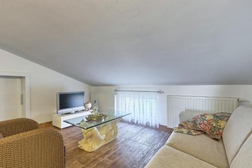 a living room with a couch and a table at Villa Mihaela in Fažana