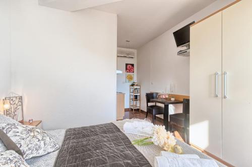 a bedroom with a bed and a desk in a room at Villa Mihaela in Fažana