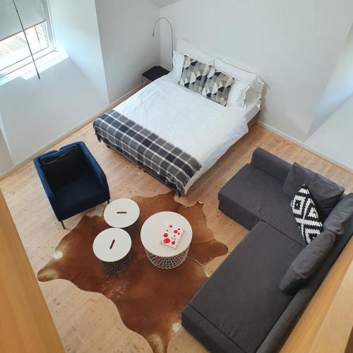 a living room with a bed and a couch at Top City Center Apartments location next to Lion Monument in Luzern