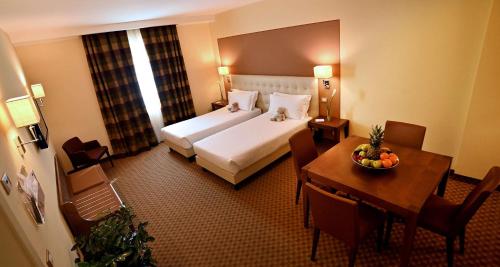 Voodi või voodid majutusasutuse Best Western Grand Hotel Guinigi toas
