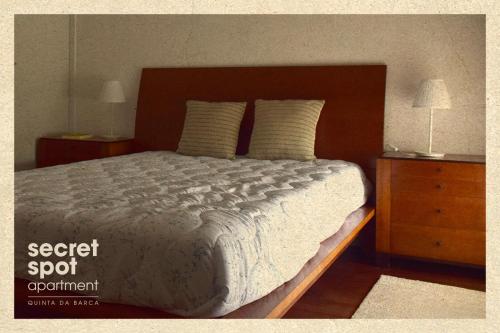 a bedroom with a large bed and two night stands at Secret Spot Apartment - Quinta da Barca in Esposende
