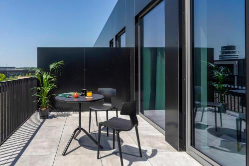 a patio with a table and chairs on a balcony at INNSiDE by Meliá Luxembourg in Luxembourg
