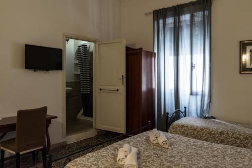 a hotel room with two beds and a mirror at Antica Terrazza Frascati in Frascati