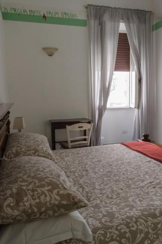a bedroom with a bed and a window at Antica Terrazza Frascati in Frascati