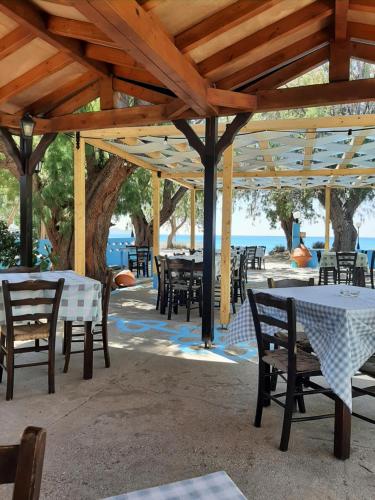 a group of tables and chairs under a pavilion at Pension Balos in Koumeika