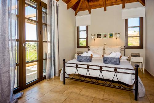 A bed or beds in a room at Filon Ktima Beachfront Upscale Villa