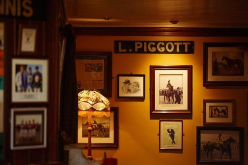 a room with pictures on a wall with a lamp at Horse & Jockey Hotel in Horse and Jockey