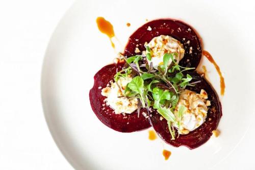 a white plate with a dish of food on it at Horse & Jockey Hotel in Horse and Jockey