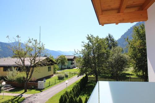 a view from the balcony of a house with a street at Apartments MountainView in Maishofen