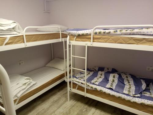 a room with three bunk beds in it at Женский Hostel Dvor in Odesa