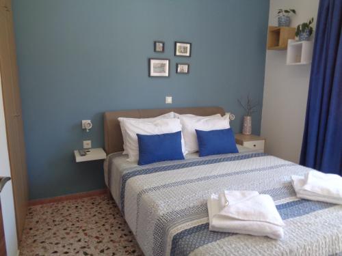 a blue bedroom with a bed with towels on it at Comfortable central apartment in Heraklio